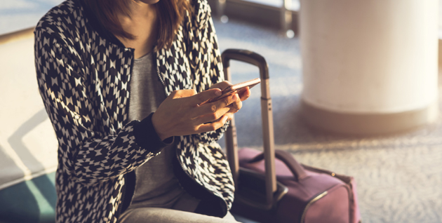 woman looking at phone at airport